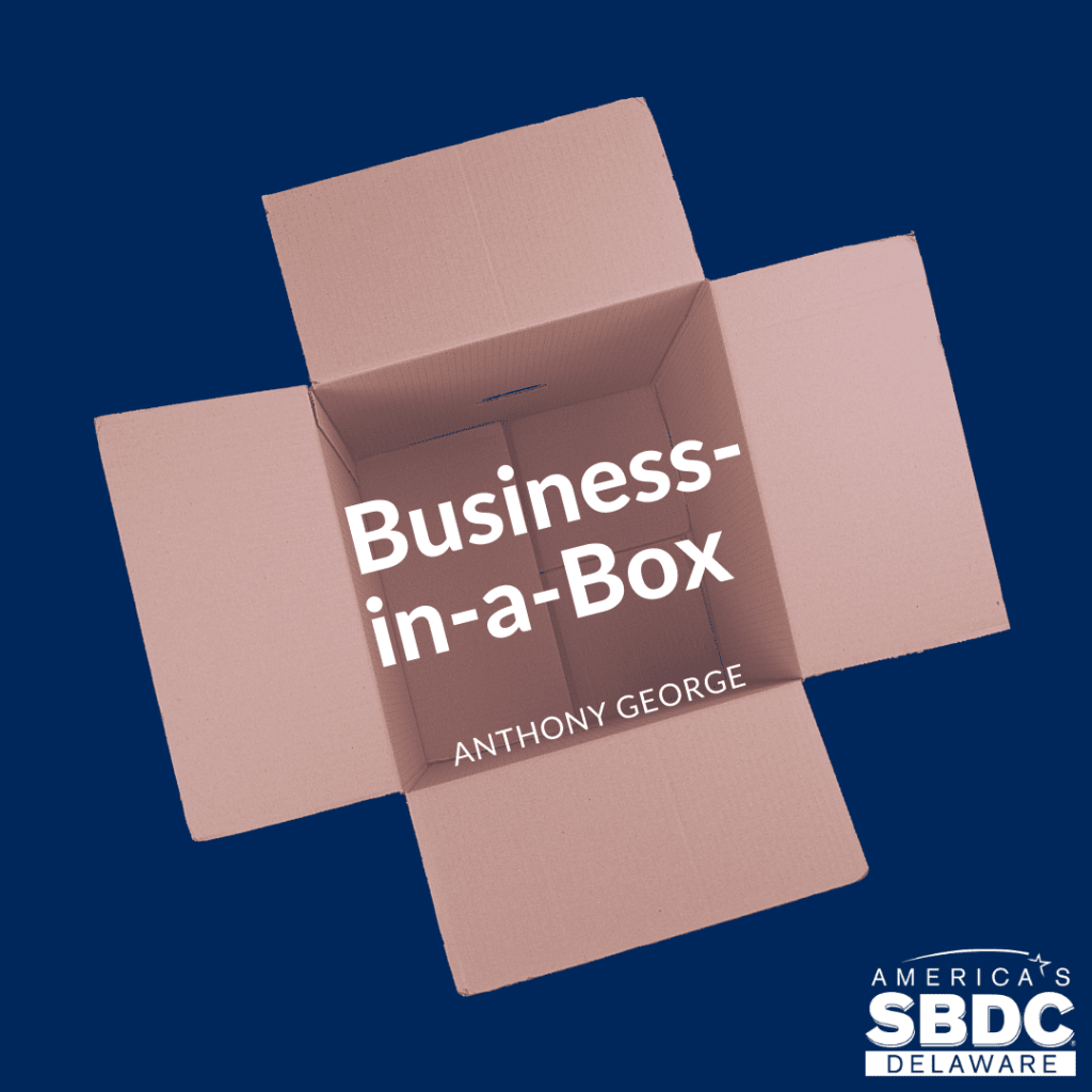 An opened brown box with the inscription Business in a box.