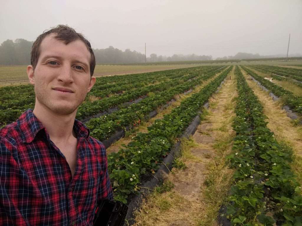 A man standing on a large farm