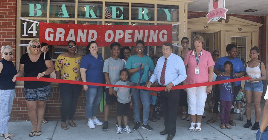 A crowd at the grand opening of a bakery