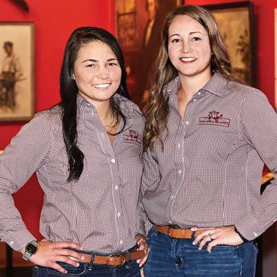 Two women in a matching shirt and jeans