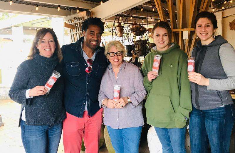 Five people smiling and holding ice pops
