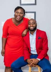 Founders of One Way Insurance dressed in red and smiling in a picture