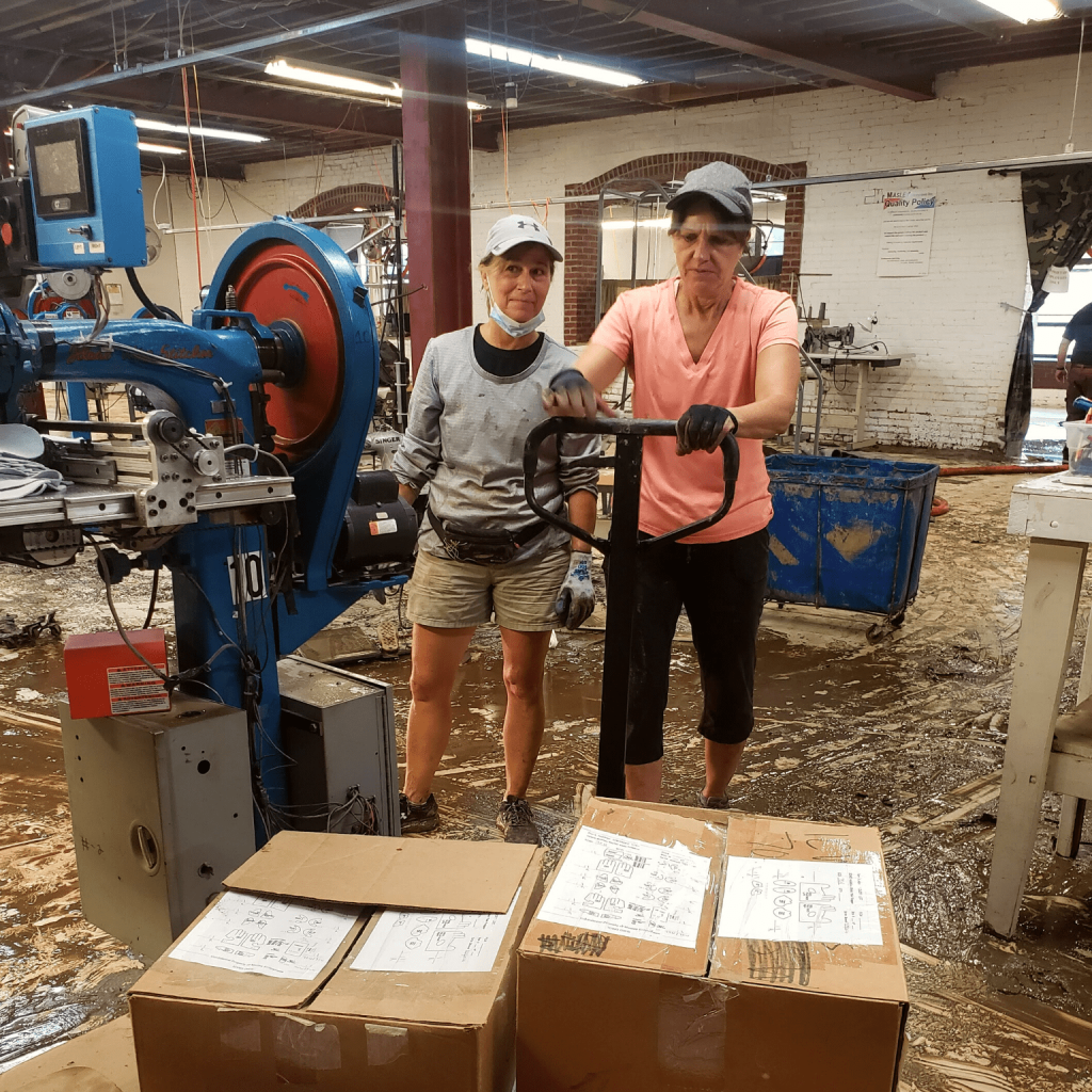 Two volunteers moving boxes