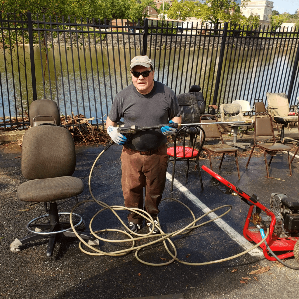 A male volunteer holding a cleaning machine