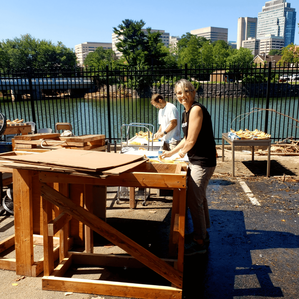 Two volunteers working on some wood structures.