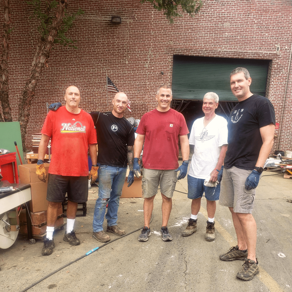 A group of men volunteering at Masley Glove