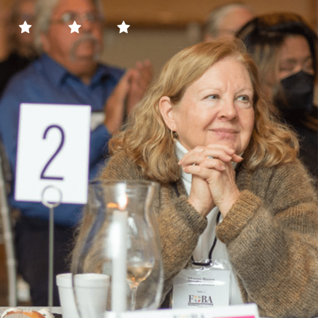 A picture of a woman sitting on table 2 at an event