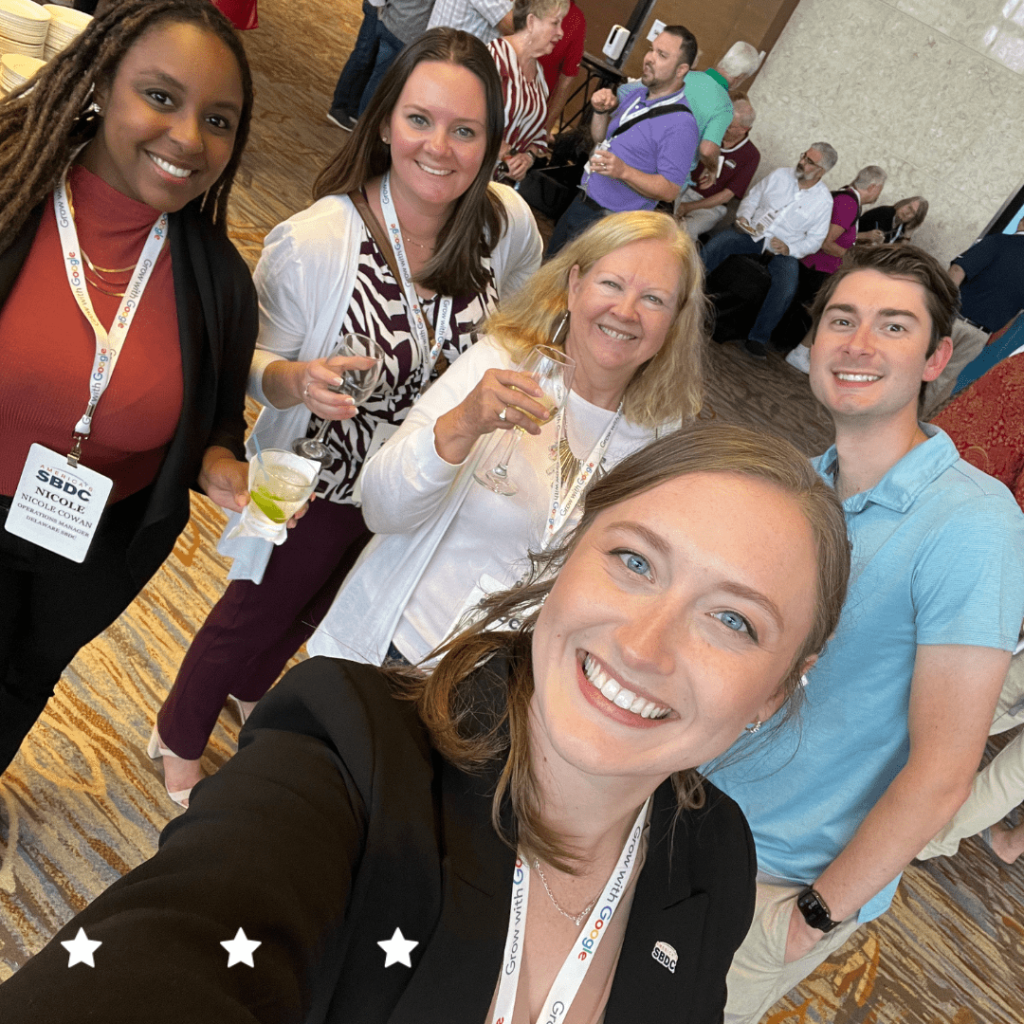 Five Delaware SBDC advisors and staff smiling in a selfie