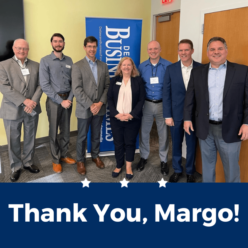 Delaware SBDC advisors and other professionals standing in a room with the inscription, Thank you, Margo!