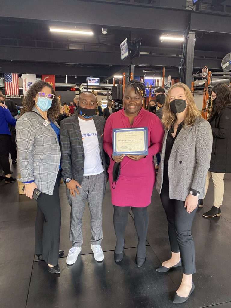 A group of people at an event holding an award