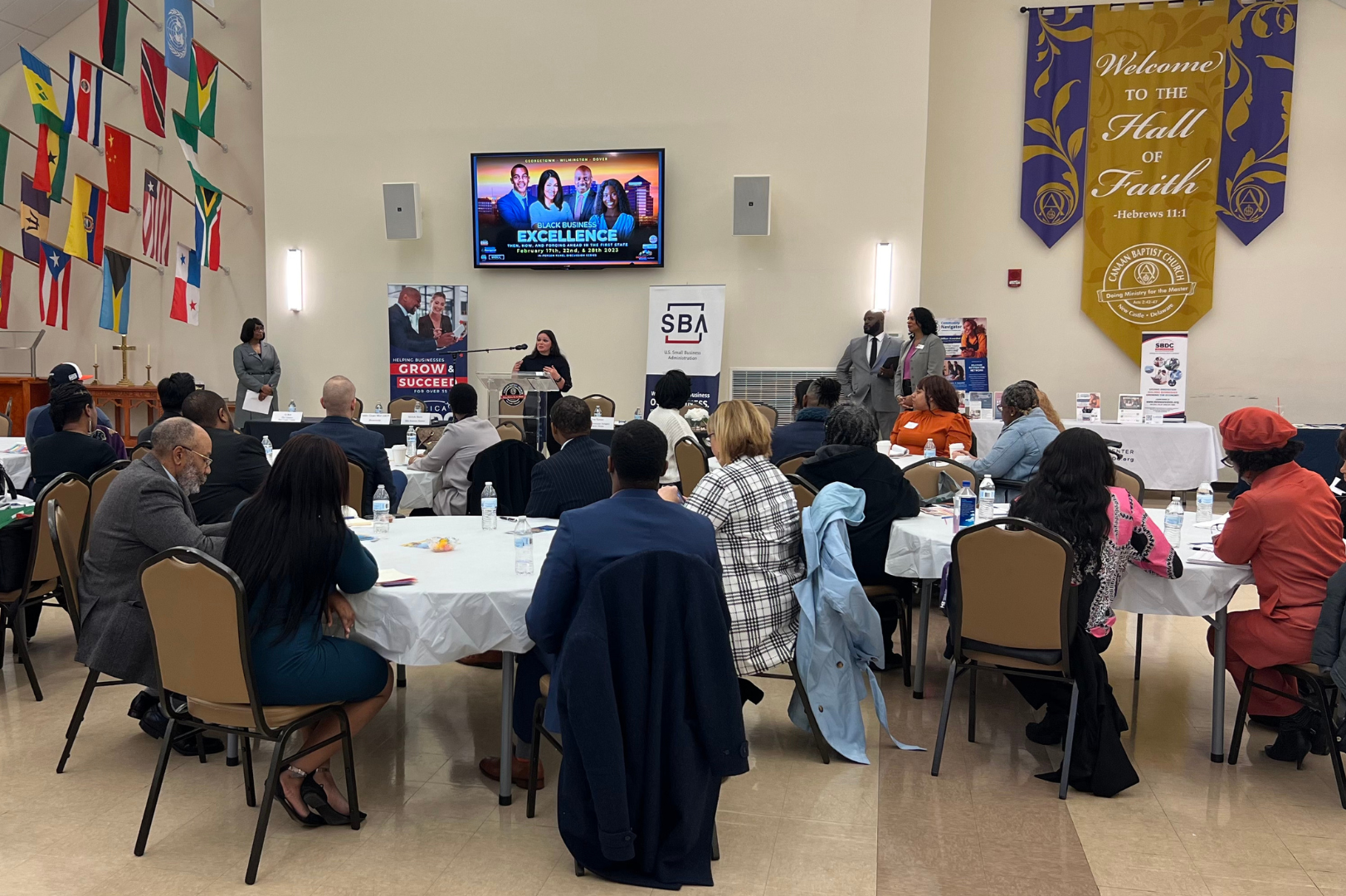 A crowd of professionals listening to a presentation.