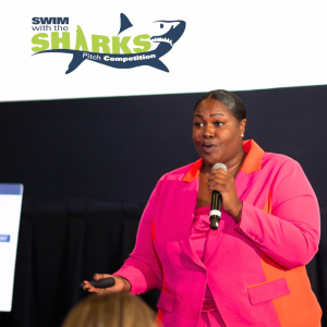A black woman speaking at the Swim with the Sharks Pitch Competition.