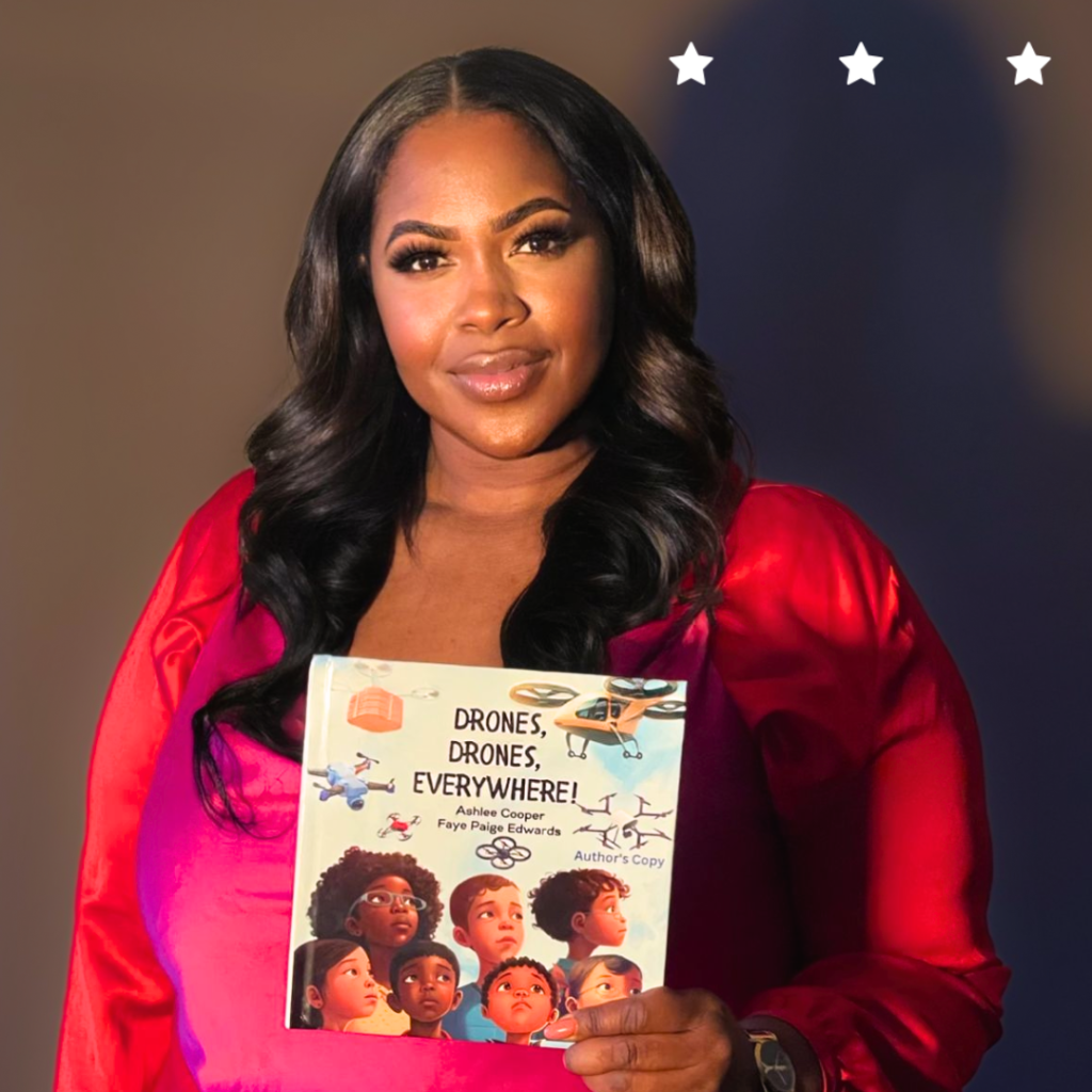 Delaware SBDC Client Droneversity black woman holding out a book.