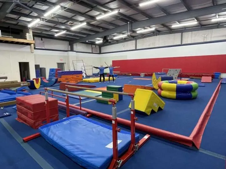 Two gymnasts at a children's gym.