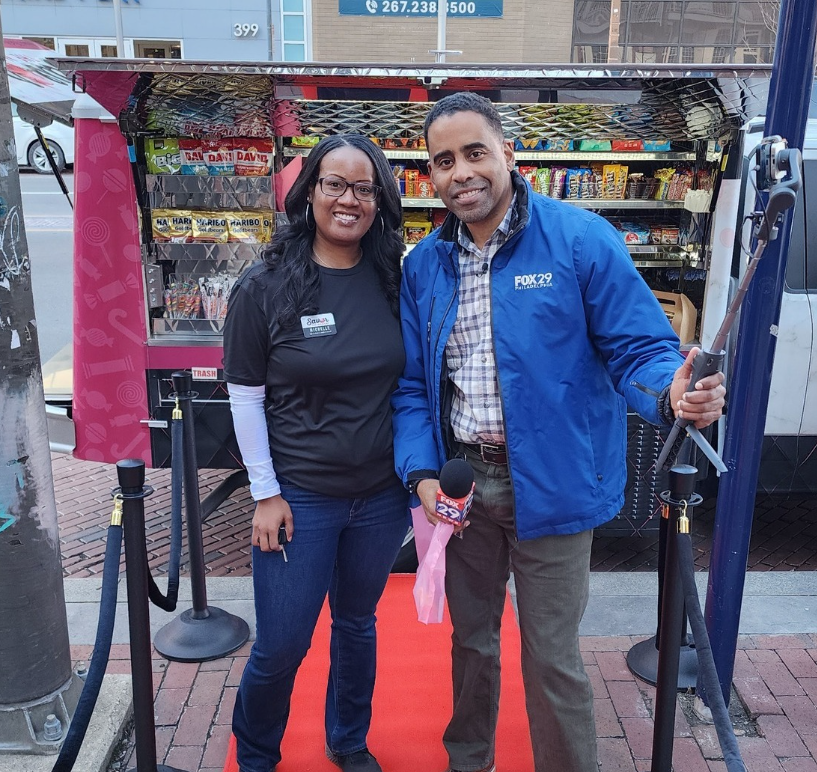 Delaware SBDC Client Savor the Moment business partners standing in front of a food truck at the grand opening.