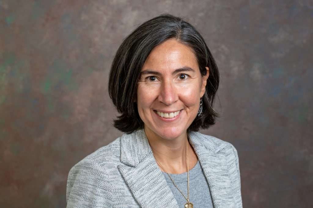 A headshot of a woman in a professional attire