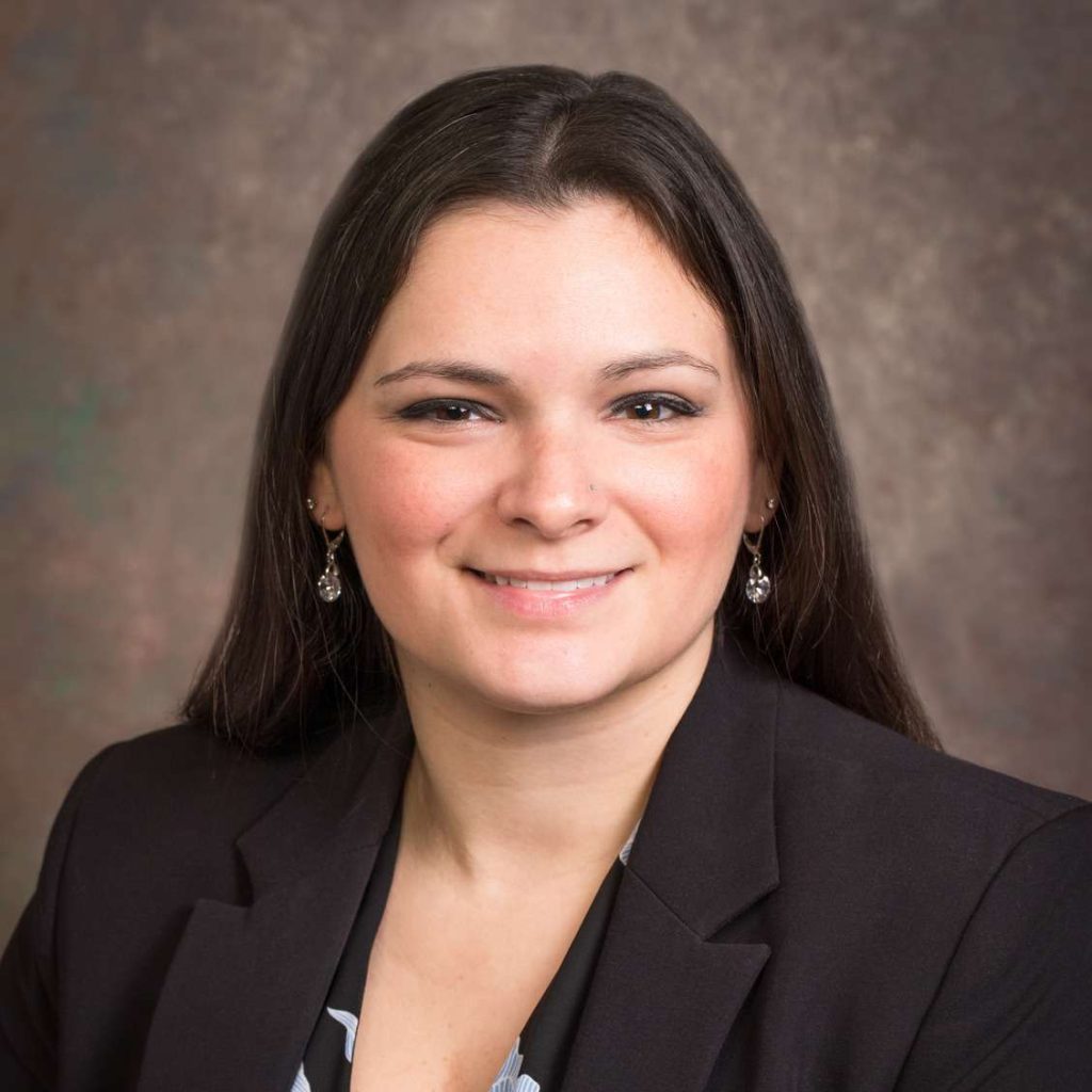 A headshot of a woman in professional attire
