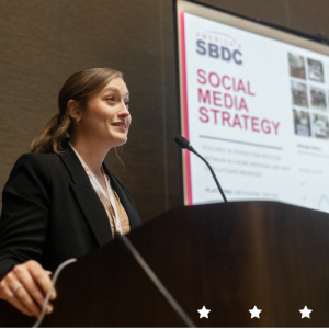 A lady in professional attire giving a lecture on Social Media Strategy.