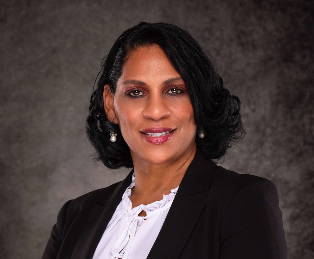 A professional headshot of a Delaware business advisor in business attire.