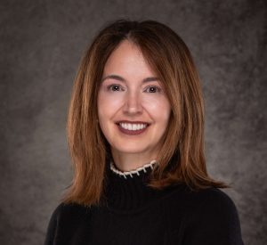 A professional headshot of a woman in business attire.