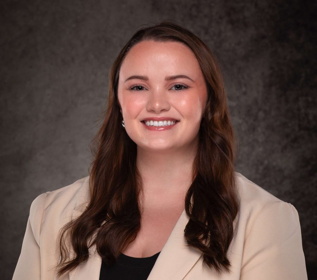 A professional headshot of a woman in business attire.