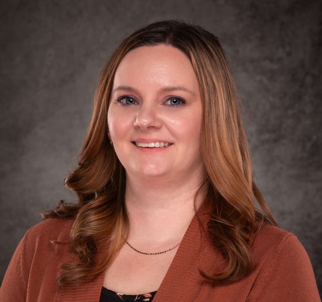 A professional headshot of a woman in business attire.