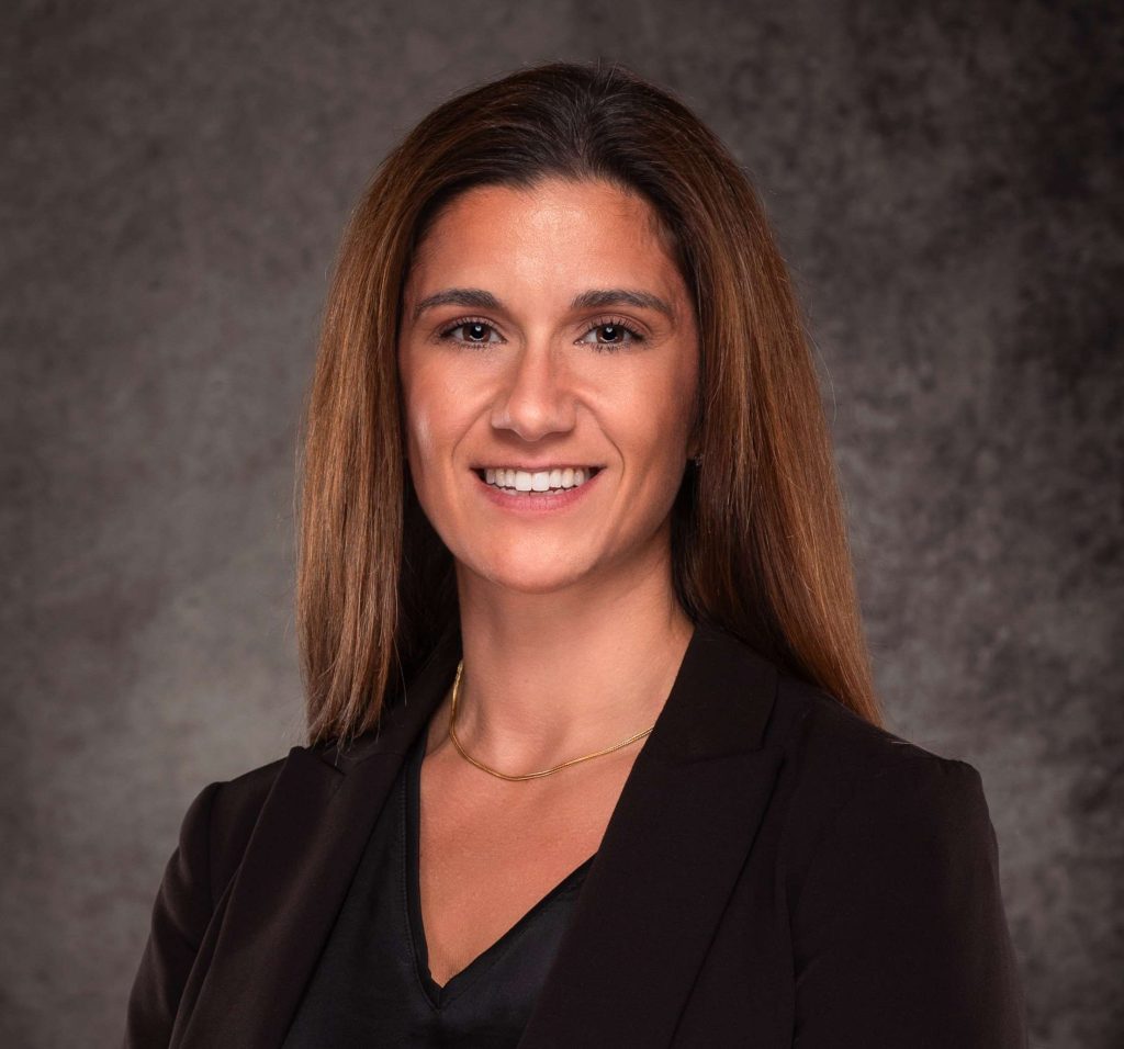 A professional headshot of a woman in business attire.