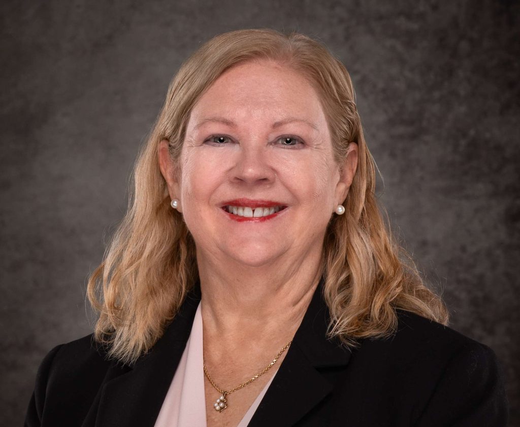 A professional headshot of a Delaware business advisor in business attire.