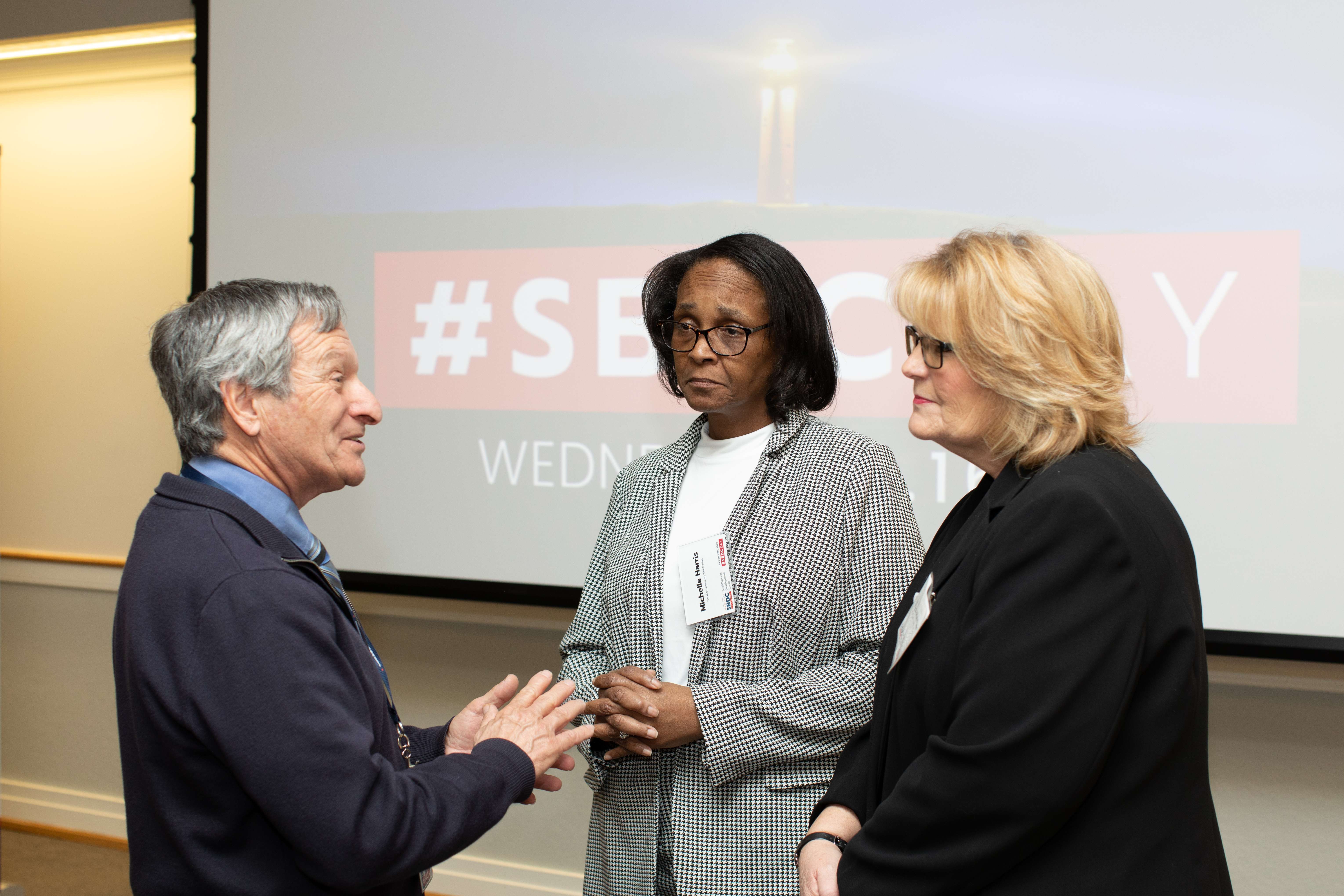 Delaware business advisor speaking with two women