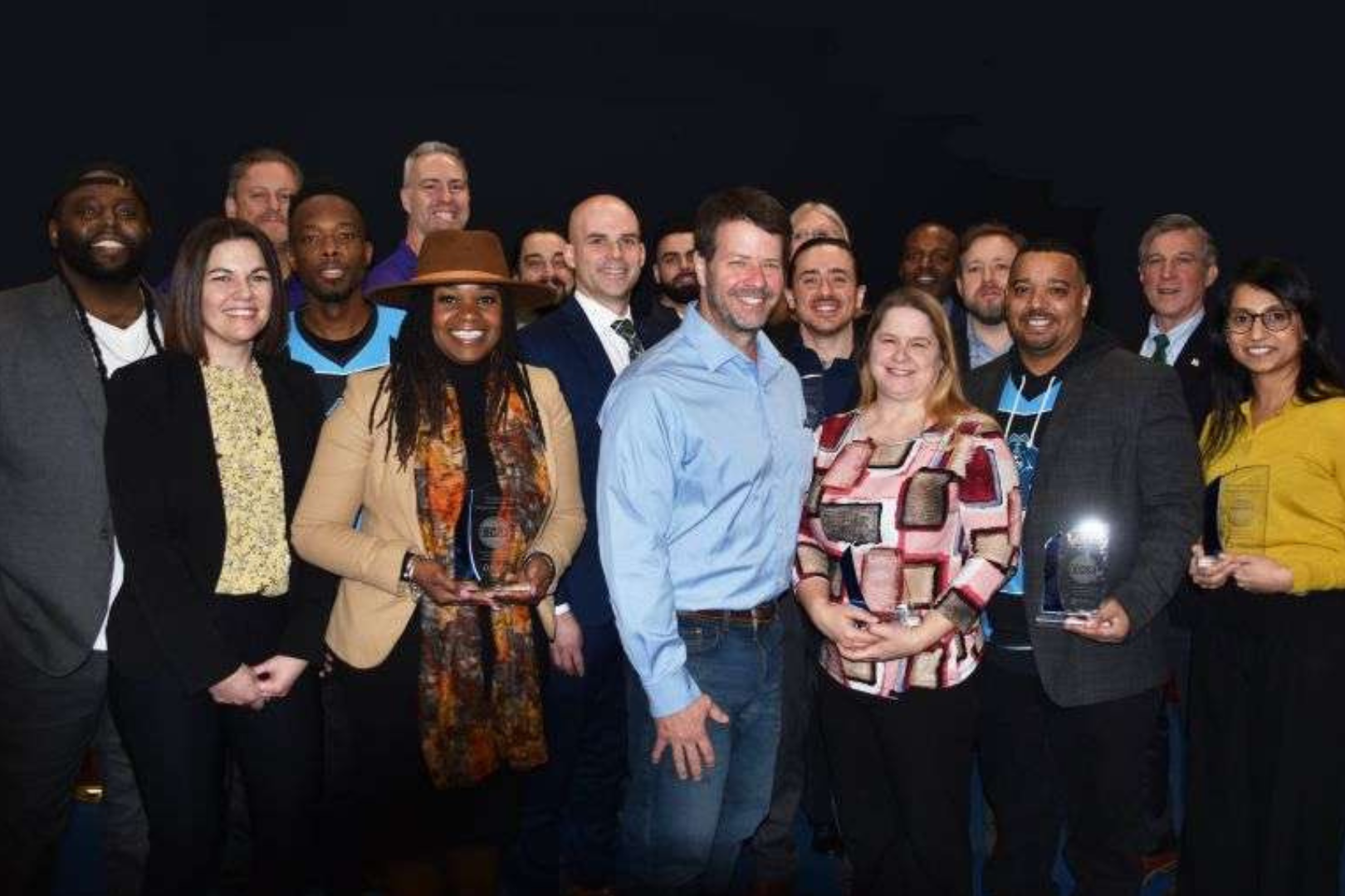 A group of people smiling at the camera for a photo.