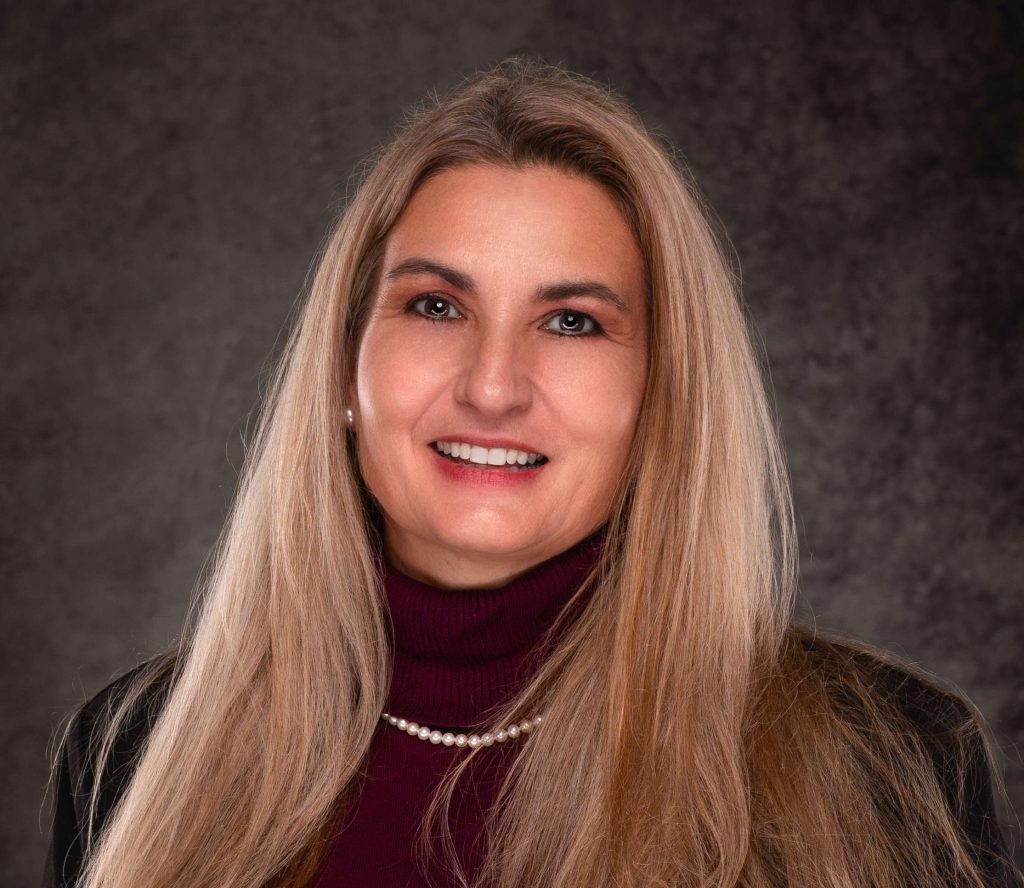 A professional headshot of a Delaware business advisor in business attire.