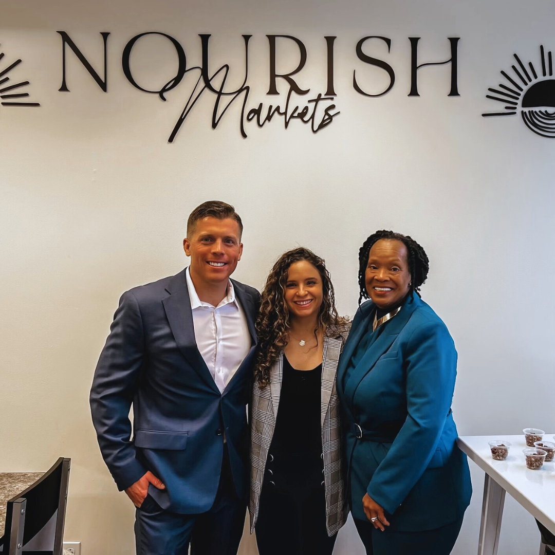 Delaware business advisor standing with business owners at the grand launch
