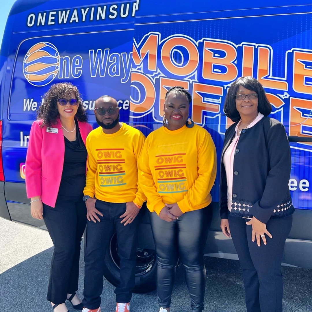 A group of people standing in front of a blue van
