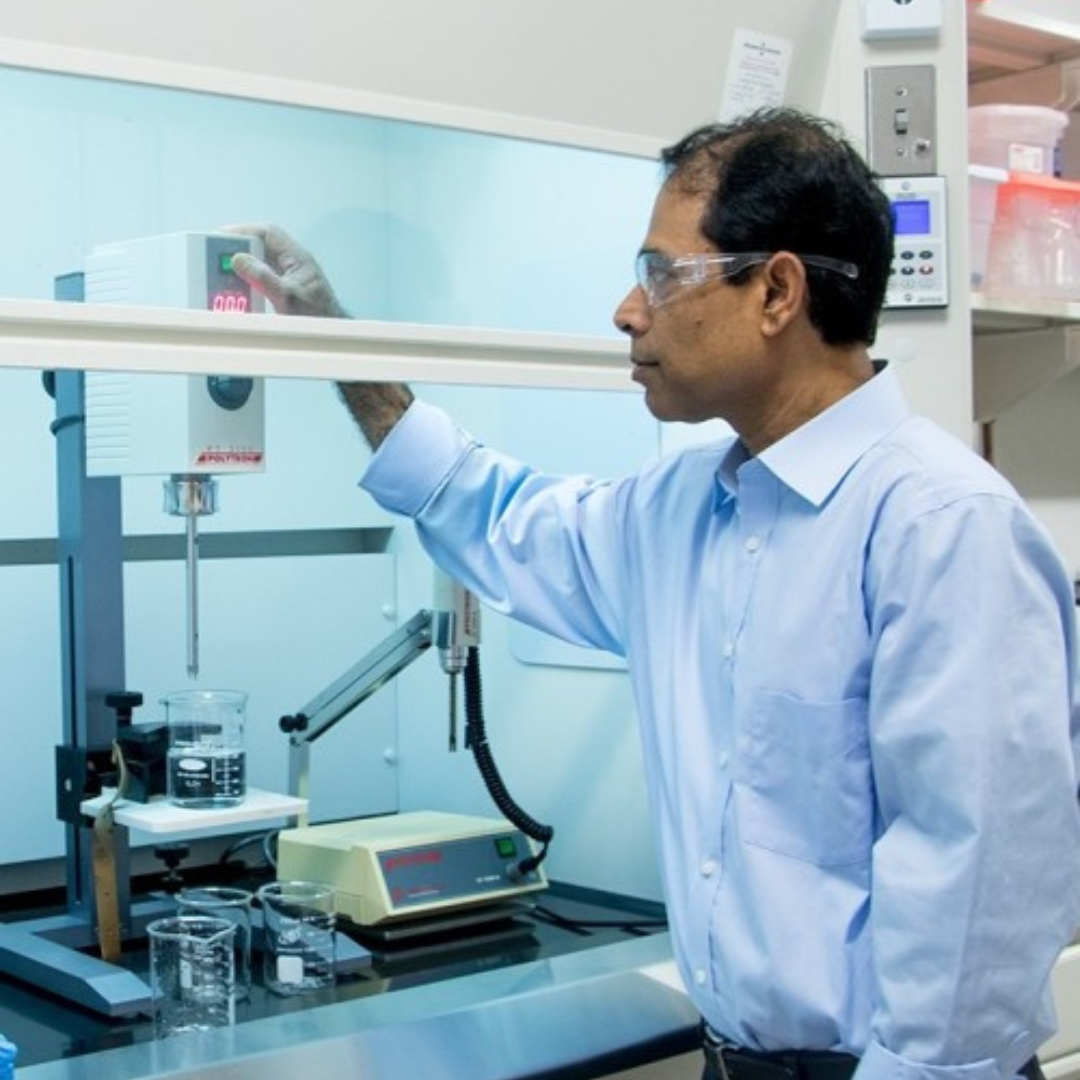 A man wearing googles and working in a lab
