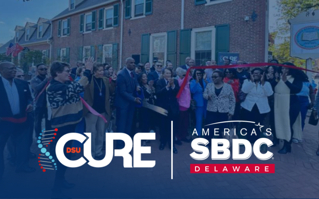A crowd at a ribbon cutting ceremony of DSU CURE and DE SBDC.