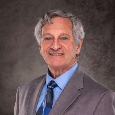 A professional headshot of a Delaware business advisor in a suit and tie.