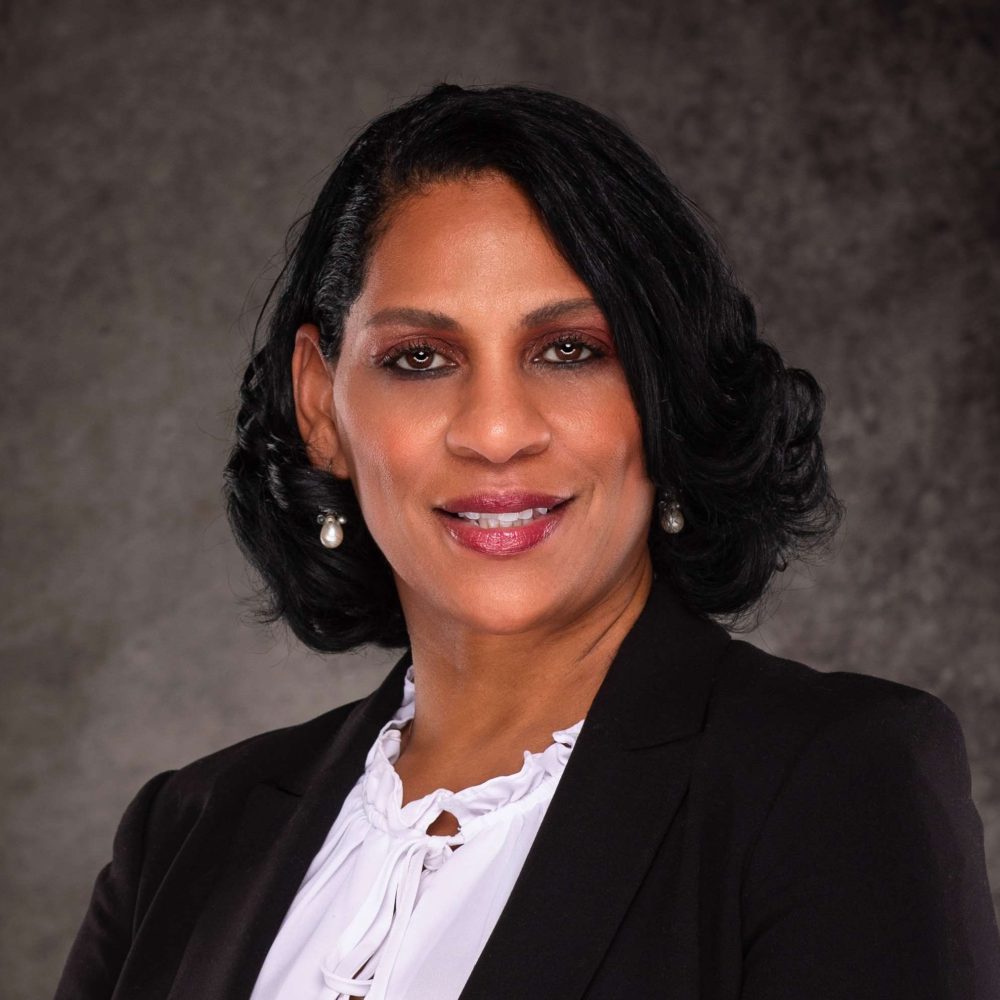 A professional headshot of a Delaware business advisor in business attire.