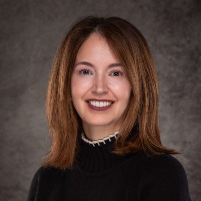 A professional headshot of a woman in business attire.