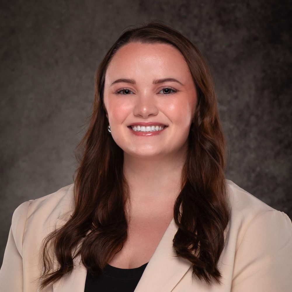 A professional headshot of a woman in business attire.