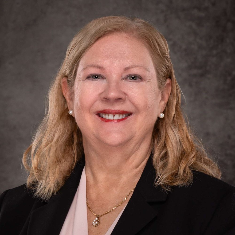 A professional headshot of a Delaware business advisor in business attire.