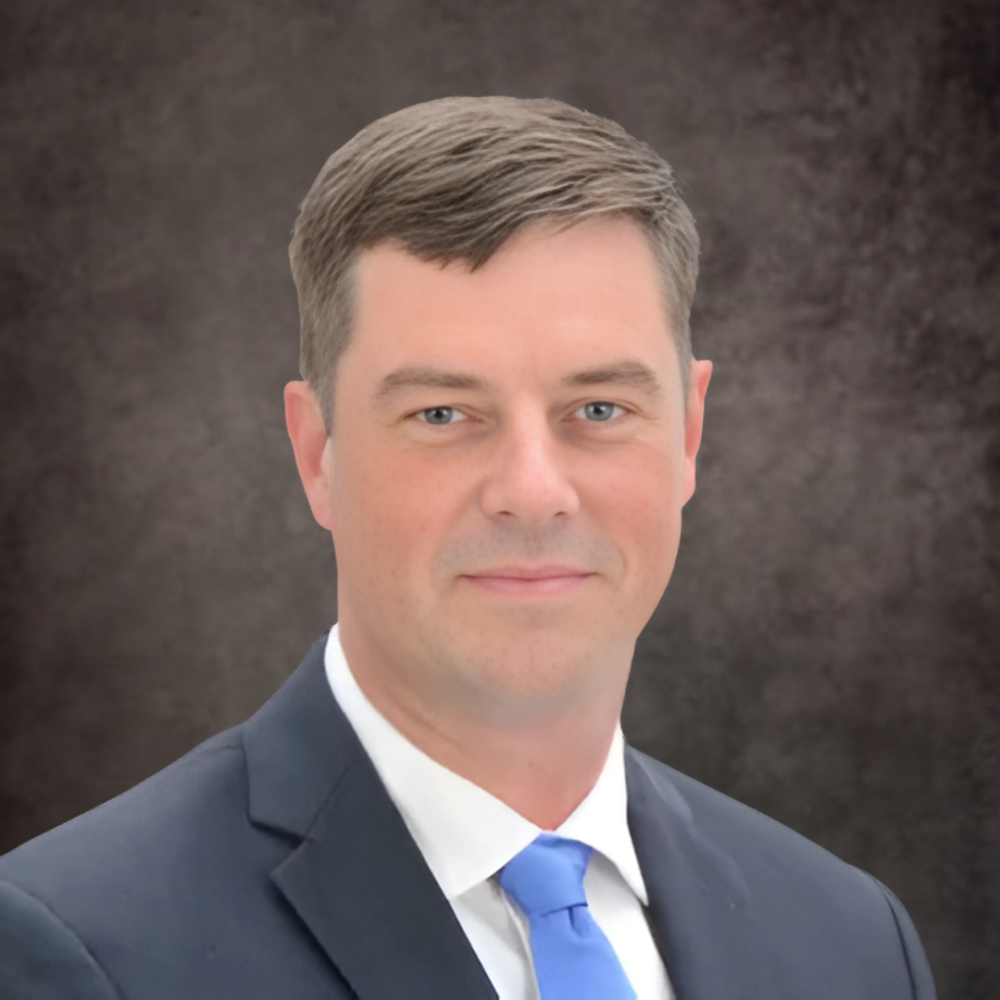 A professional headshot of a Delaware business advisor in a suit and tie.