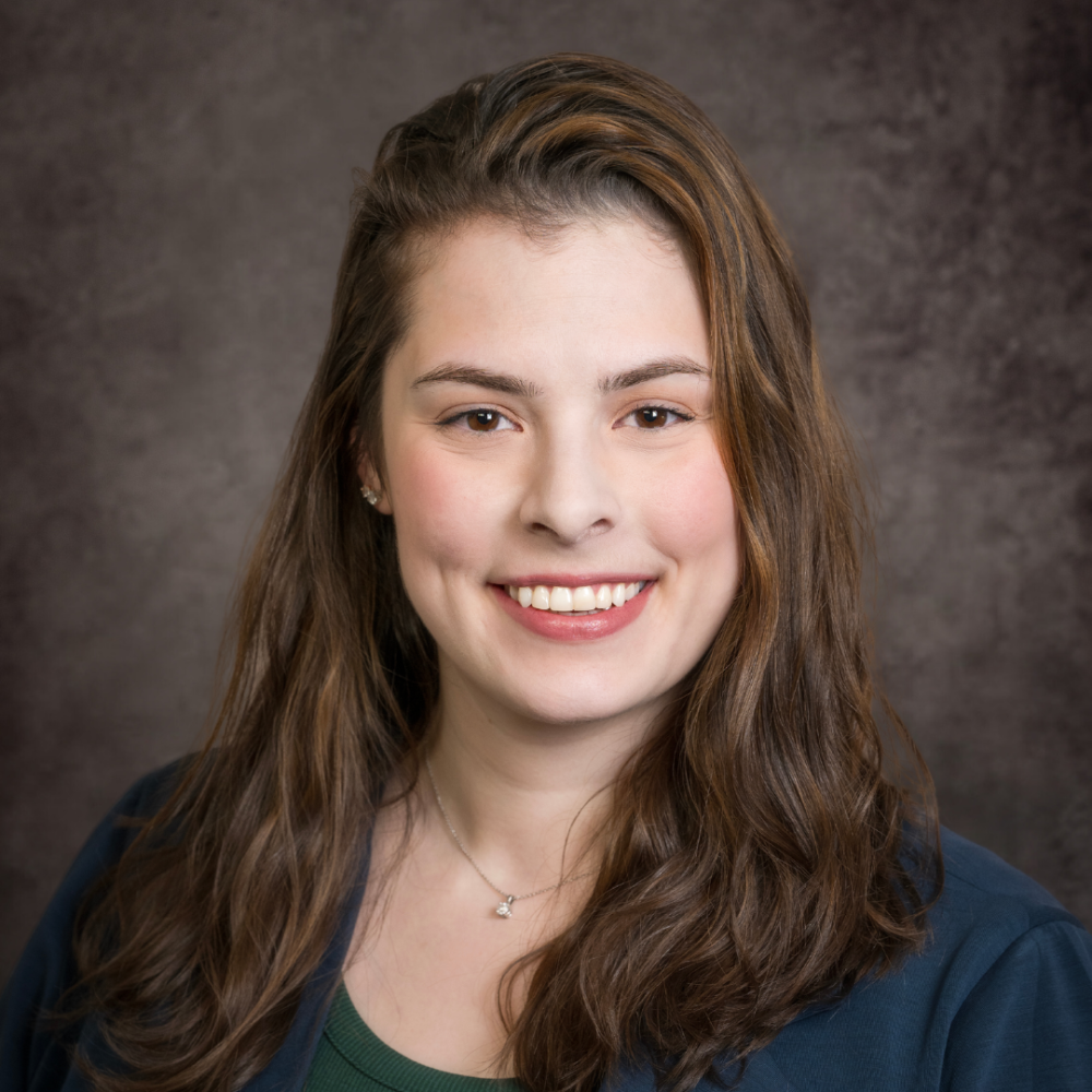 A professional headshot of a woman in business attire.