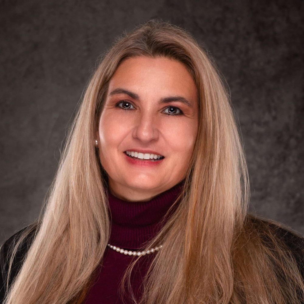 A professional headshot of a Delaware business advisor in business attire.