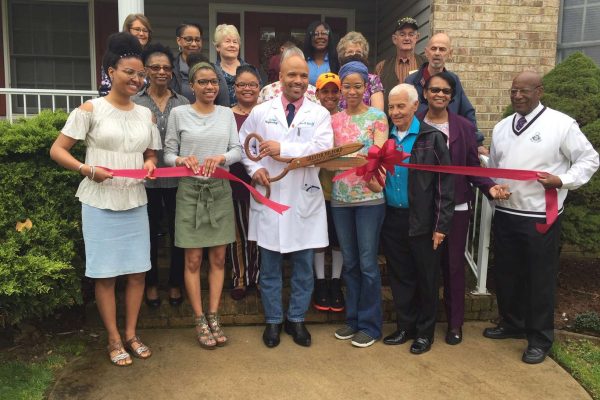 we-care-nephrology-photo A crowd cutting the ribbon at the grand launch of a health and wellness facility